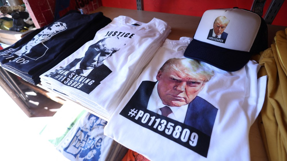 T-shirts and hats with Donald Trump's mugshot at the Y-Que printing store in Los Angeles