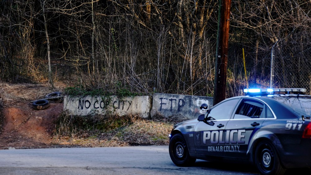 Law enforcement drive past the planned site of a police training facility that activists have nicknamed "Cop City" in Atlanta on Feb. 6, 2023.