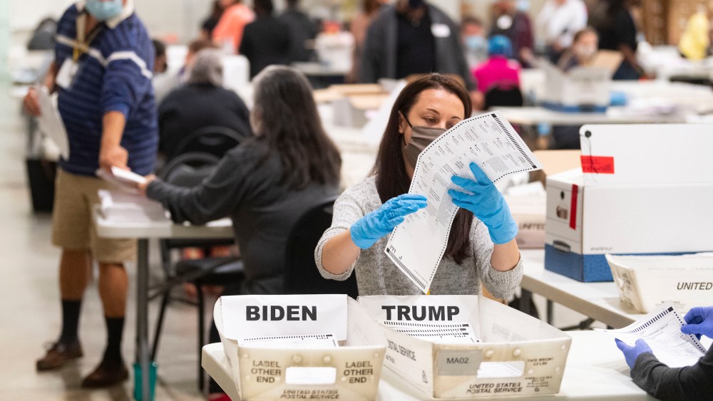An election worker looks at a ballot during a Cobb County hand recount of Presidential votes in Marietta, Ga.