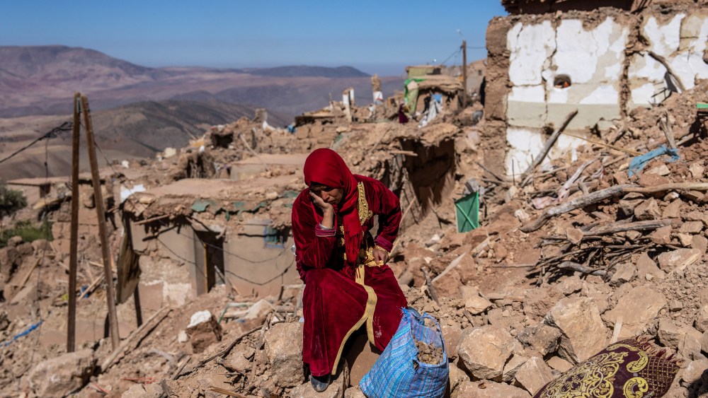 A woman sits amongst the rubble of her village in Douzrou, Morocco, on Sept. 11, 2023, that was almost completely destroyed by the earthquake three days earlier.