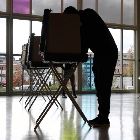 Voters mark their ballots at First Presbyterian Church in Stamford, Conn.