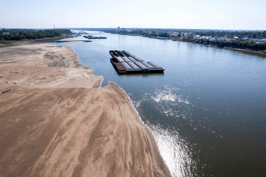 Barges float in the Mississippi River as a portion of the riverbed is exposed in St. Louis, Mo., on Sept. 15, 2023.
