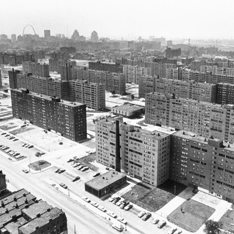 (Original Caption) St. Louis: Aerial view made June 5, 1971 shows the massive Pruitt-Igoe housing project with its busted windows and the St. Louis Gateway Arch in background. Most of the 35 buildings in the complex are vacant.