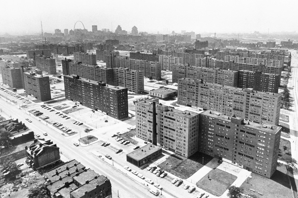 (Original Caption) St. Louis: Aerial view made June 5, 1971 shows the massive Pruitt-Igoe housing project with its busted windows and the St. Louis Gateway Arch in background. Most of the 35 buildings in the complex are vacant.