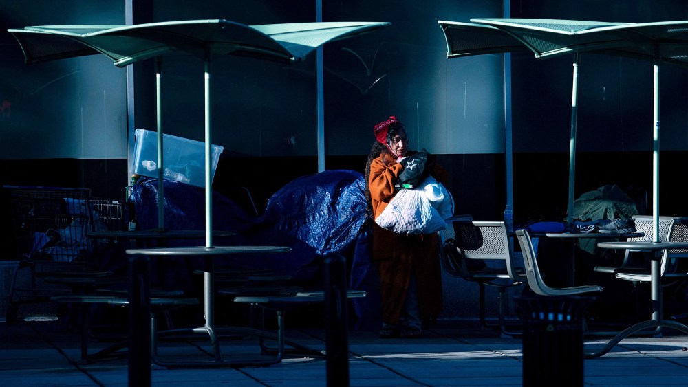 A homeless person collects her belongings in Washington.