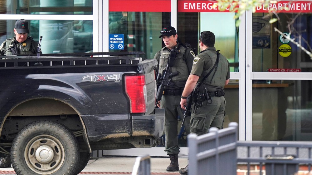 Law enforcement officers near an emergency department entrance at Central Maine Medical Center during an active shooter situation, in Lewiston