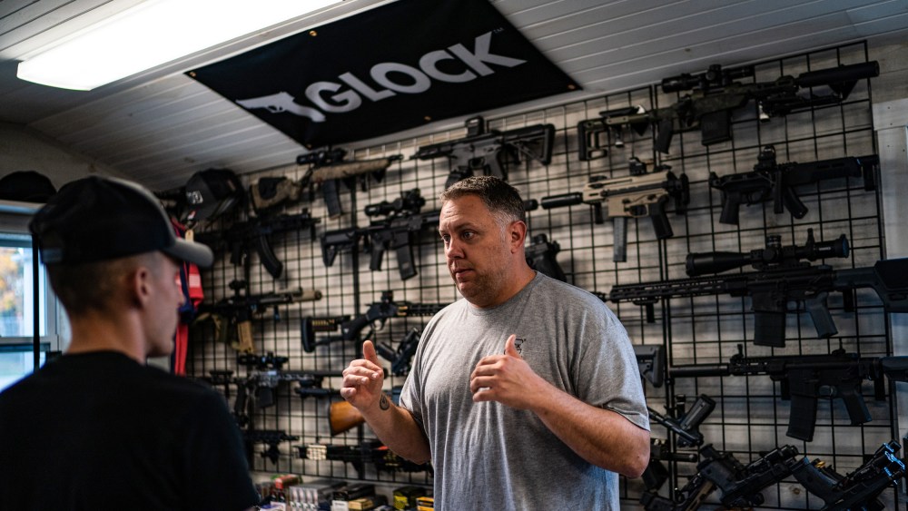 Nate Maillet, right, the owner of First Due Firearms, helps a first buyer customer in Sabattus, Maine