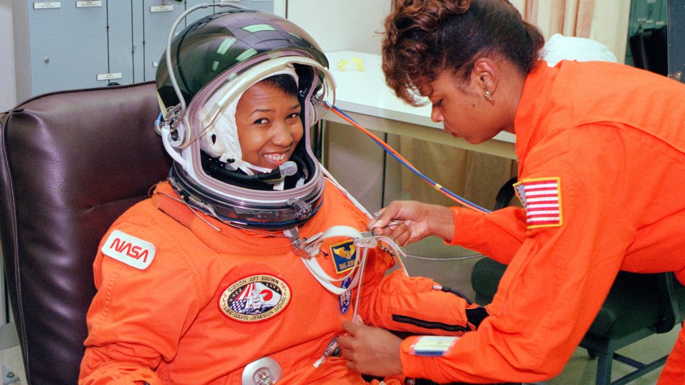 Mae Jemison smiles as a technician performs tests on her spacesuit.