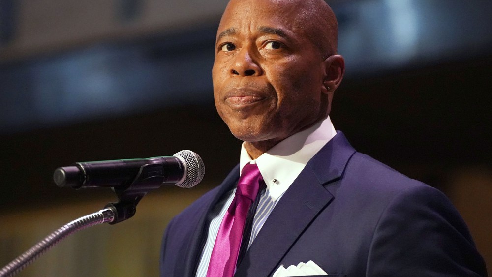 Mayor Eric Adams speaks onstage at a podium