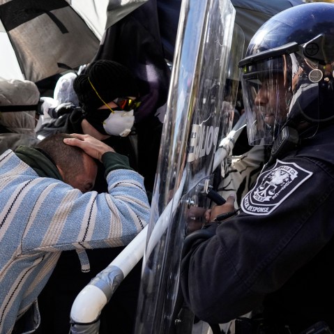 Protesters drive into a police line during a demonstration in opposition to a new police training center, in Atlanta