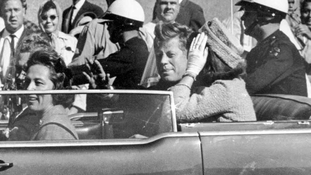 Former President John F. Kennedy waves from his car in a motorcade approximately one minute before he was shot in Dallas, Texas on Nov. 22, 1963.