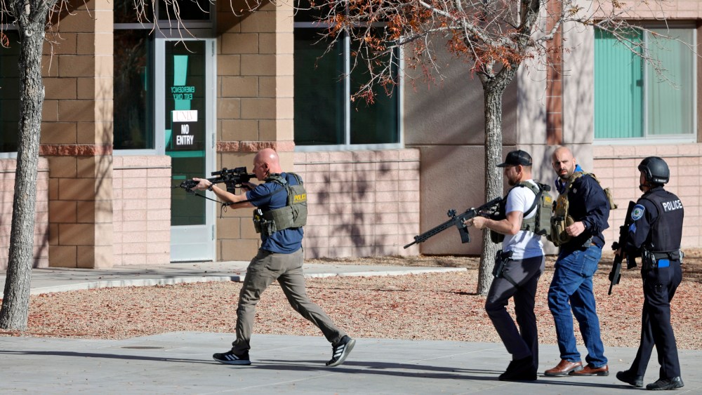 Law enforcement officers head into the University of Nevada, Las Vegas, after reports of an active shooter, Wednesday, Dec. 6, 2023, in Las Vegas.