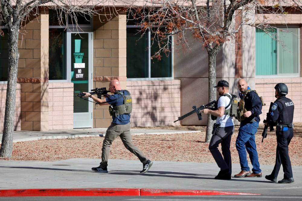 Law enforcement officers head into the University of Nevada, Las Vegas, after reports of an active shooter, Wednesday, Dec. 6, 2023, in Las Vegas.