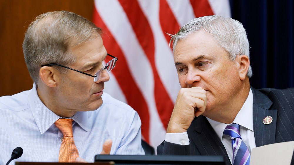 Reps. Jim Jordan and James Comer talk during a hearing on Capitol Hill.