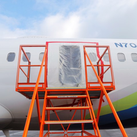 Plastic covers the hole where the door plug had been on Alaska Airlines Flight 1282.