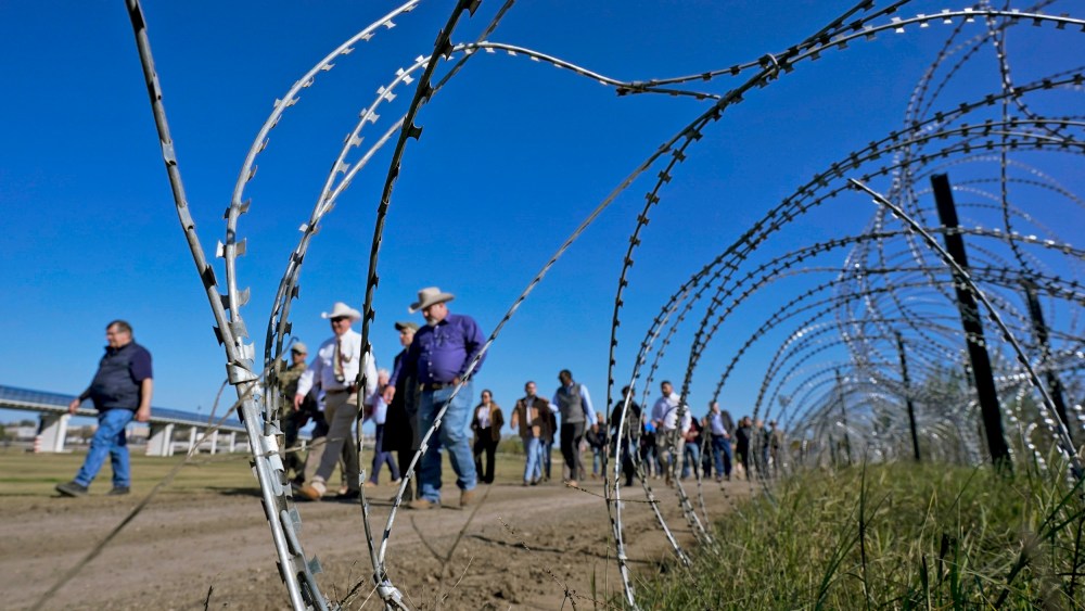 Members of Congress pass concertina wire as they tour the border with Mexico on Jan. 3, 2024, in Eagle Pass, Texas.
