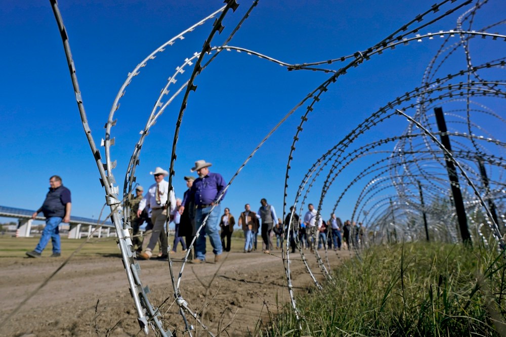Members of Congress pass concertina wire as they tour the border with Mexico on Jan. 3, 2024, in Eagle Pass, Texas.