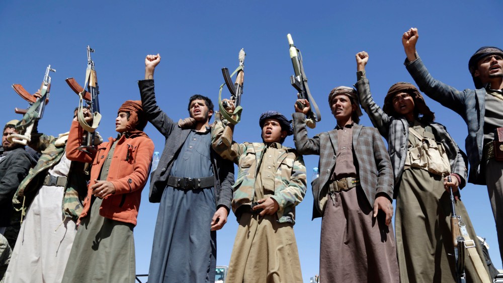 Houthi followers lift rifles and shout slogans against the U.S.-U.K. during a tribal gathering on January 14, 2024 on the outskirts of Sana'a, Yemen.