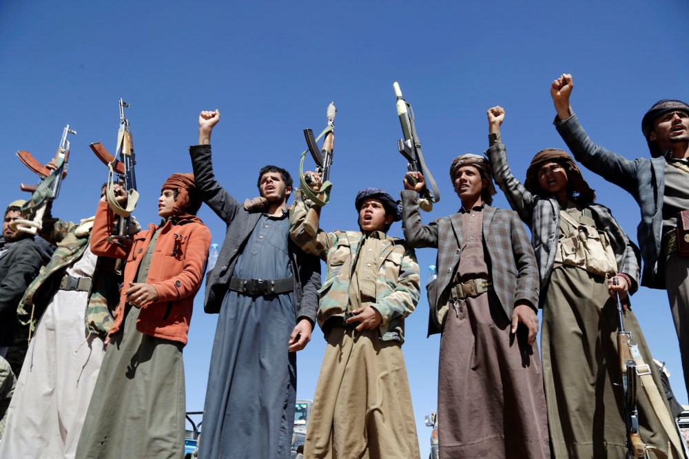 Houthi followers lift rifles and shout slogans against the U.S.-U.K. during a tribal gathering on January 14, 2024 on the outskirts of Sana'a, Yemen.