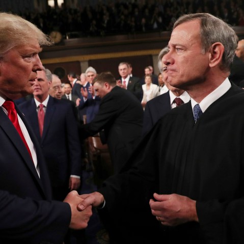 Former President Donald Trump greets Supreme Court Chief Justice John Roberts as he arrives to deliver his State of the Union address at the U.S. Capitol in 2020.