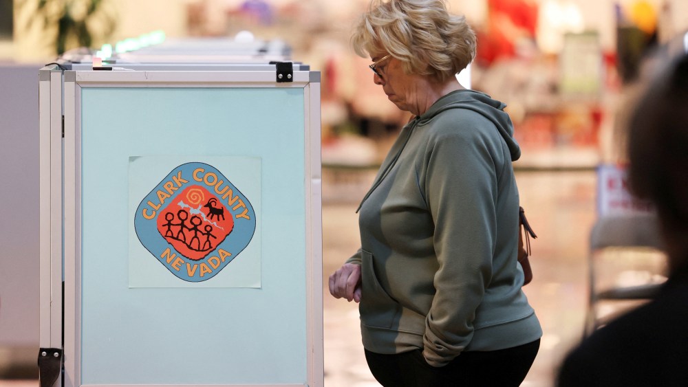 A voter casts her ballot in the state's Democratic and Republican presidential primary election in Las Vegas