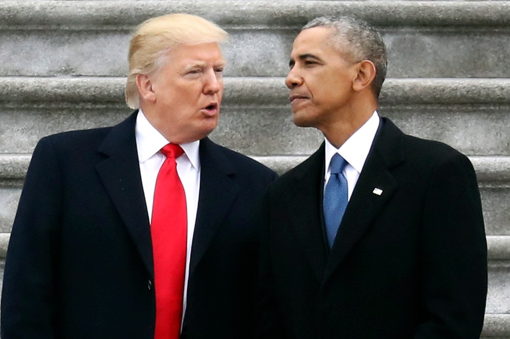 Donald Trump talks with Barack Obama.