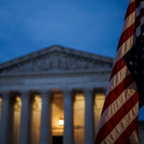 An abortion rights activist flies an upside down US flag, the international sign of distress, outside of the Supreme Court during a protest in Washington, D.C., on June 26, 2022, two days after the court scrapped half-century constitutional protections for the procedure.