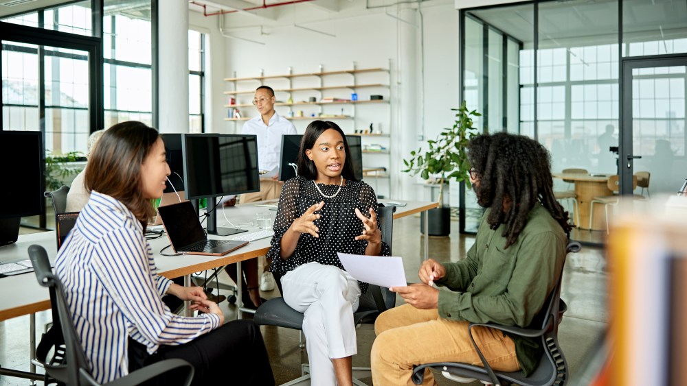 Three creative colleagues exchanging ideas