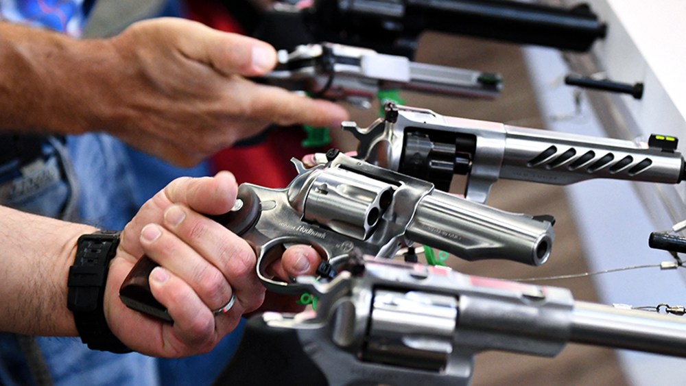 Attendees hold Ruger revolver pistols.