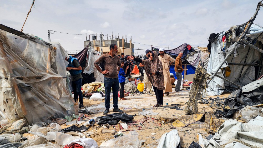 Palestinians examine the destroyed makeshift tents.