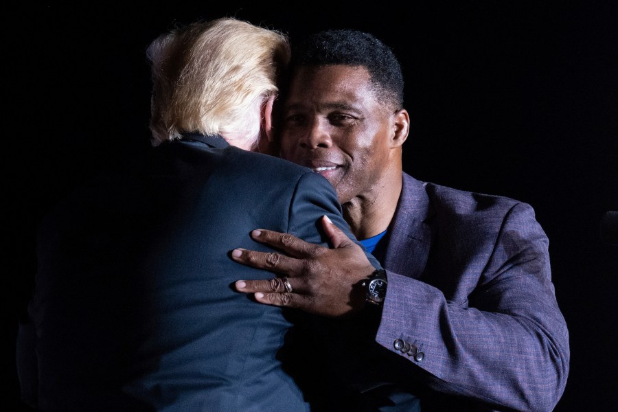 Donald Trump and Herschel Walker hug