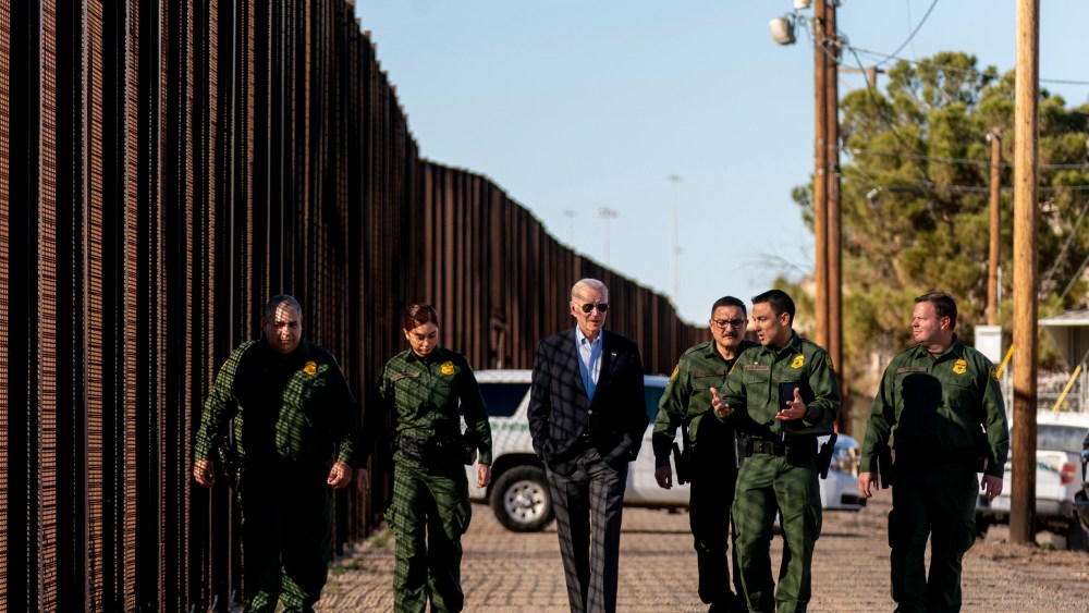 Joe Biden talks with U.S. Border Patrol agents as they walk along a stretch of the U.S.-Mexico border in El Paso Texas
