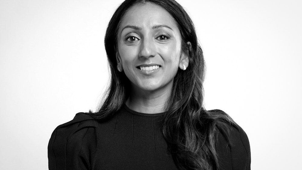 Amy Jain smiles, black and white photo