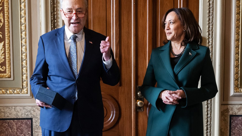Chuck Schumer speaks as Kamala Harris stands next to him