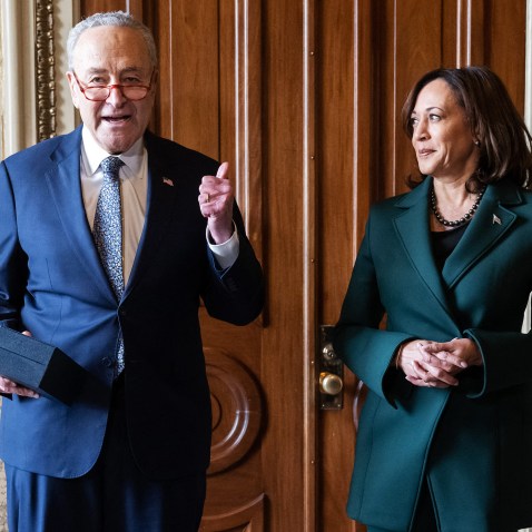 Chuck Schumer speaks as Kamala Harris stands next to him