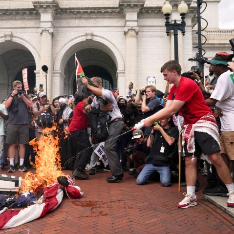 Protesters gather for Israeli PM Netanyahu's address to Congress in Washington US flag burning burners USA