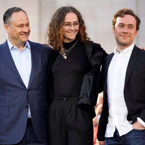 Doug Emhoff, Ella and Cole smile standing next to each other