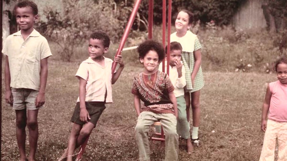 A group of children smiling outside