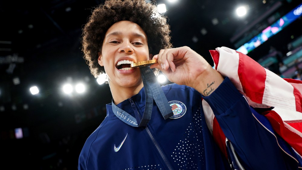 Brittney Griner bites her Olympic gold medal