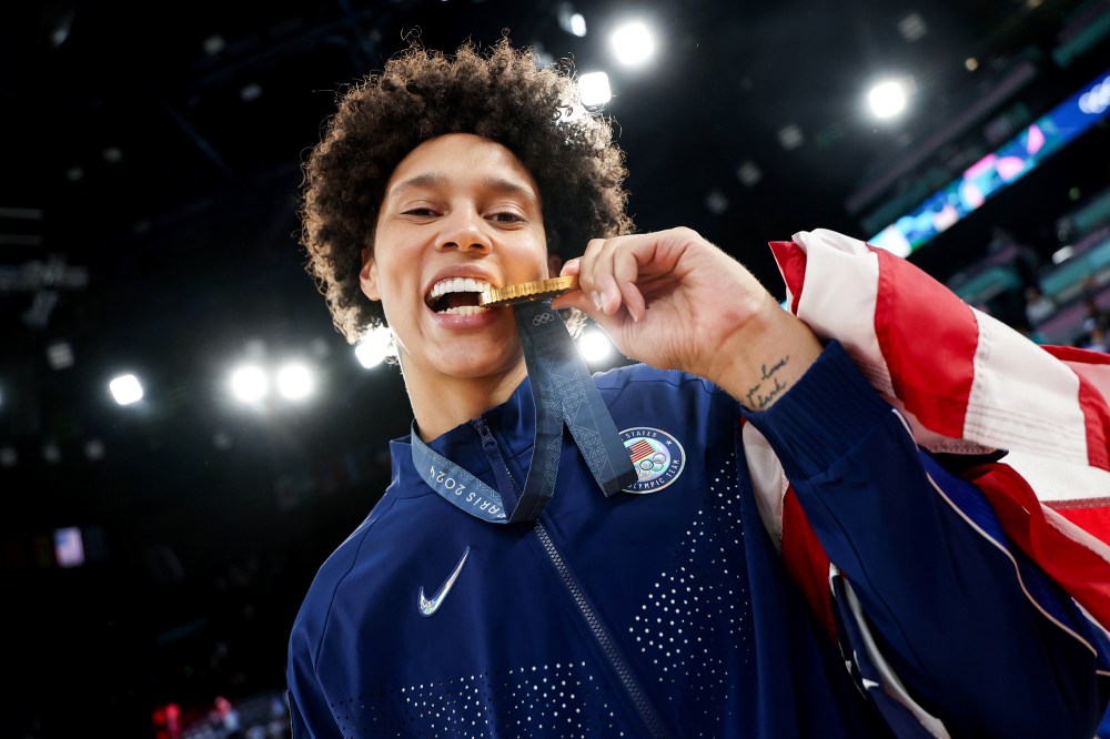 Brittney Griner bites her Olympic gold medal