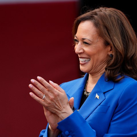 Kamala Harris smiles and claps
