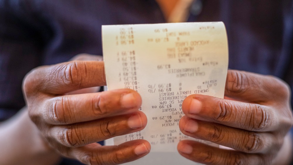 Woman holding retail receipt