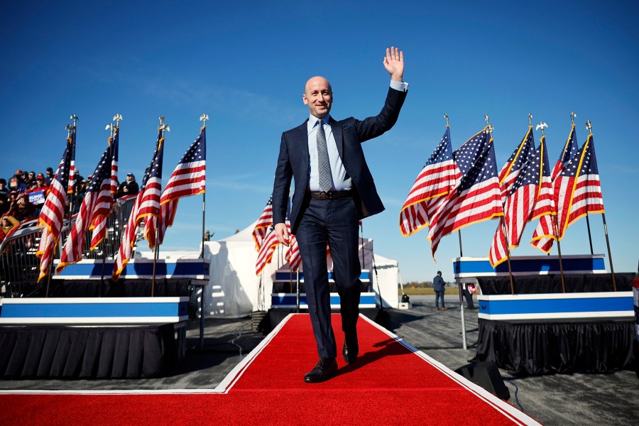 Image: stephen miller politics political wave hand gesture smile