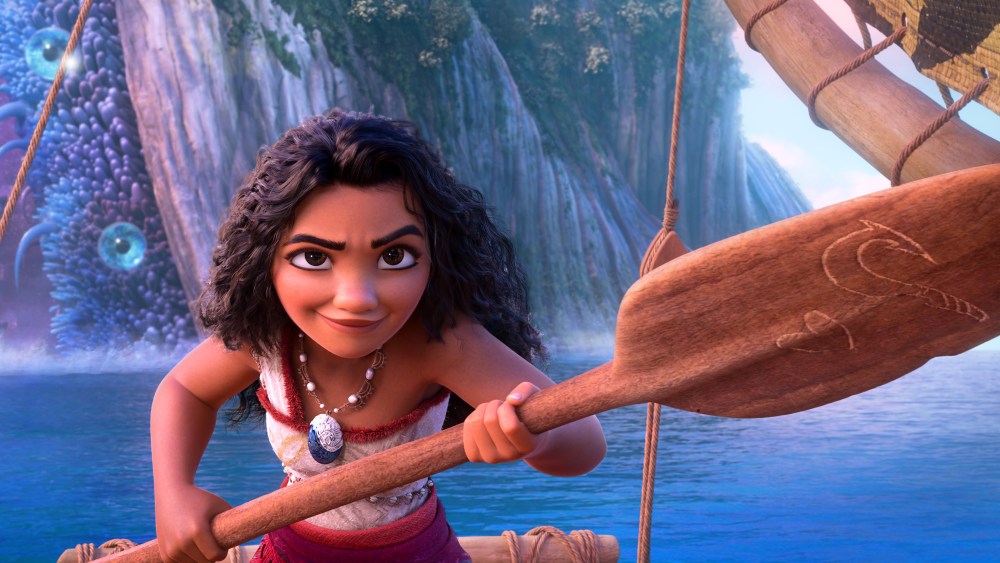 Moana holds an ore on a boat in the water