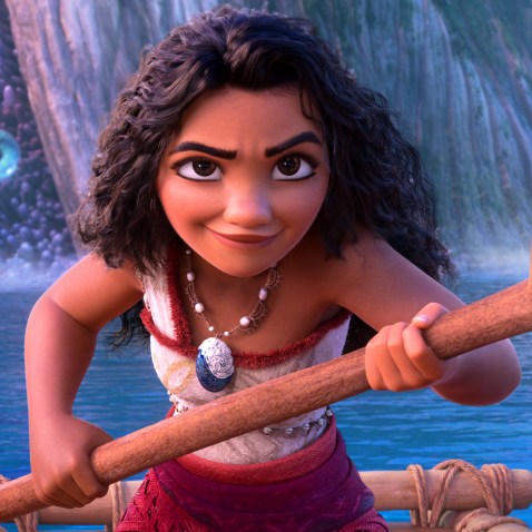 Moana holds an ore on a boat in the water