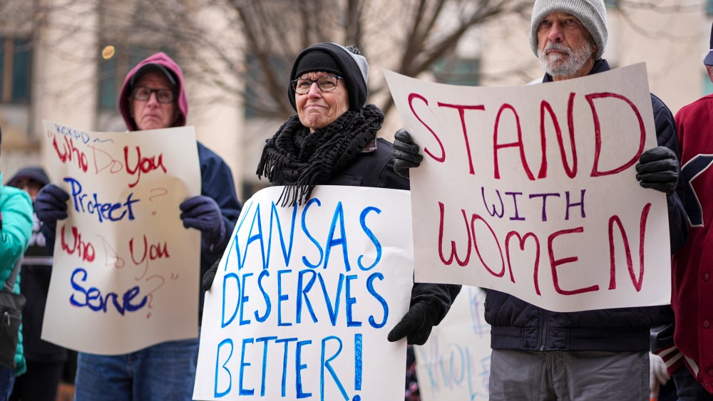 People with signs outside courthouse.
