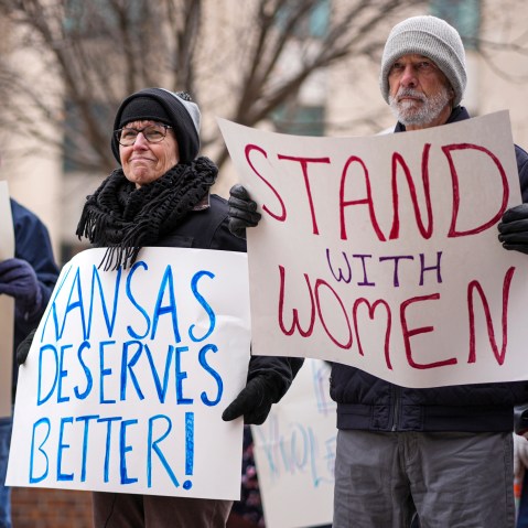 People with signs outside courthouse.