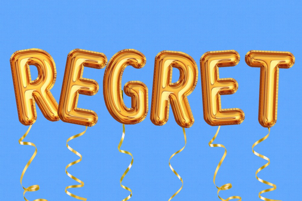 Photo illustration of gold balloons that read "Regret"