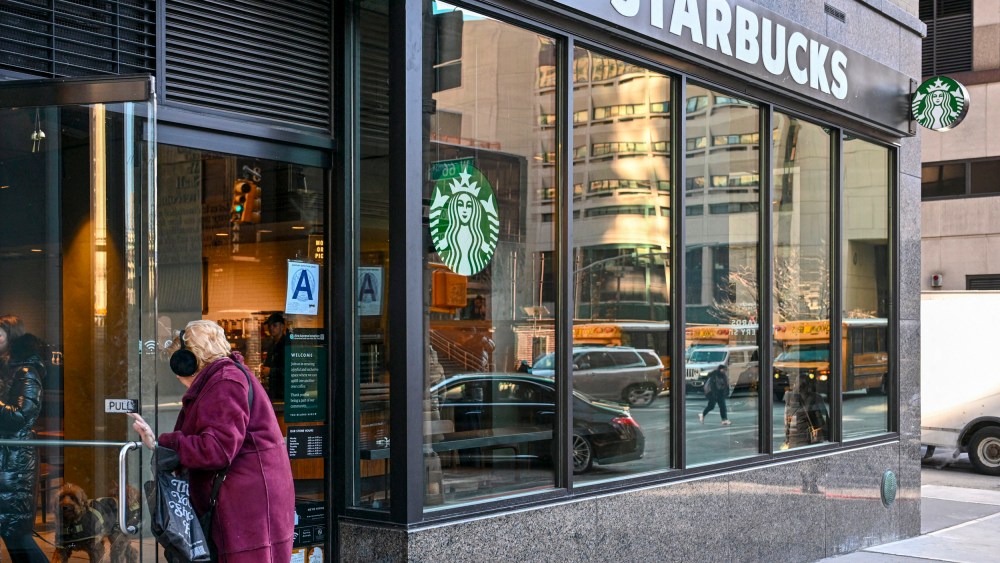 A person enters a Starbucks coffee shop.