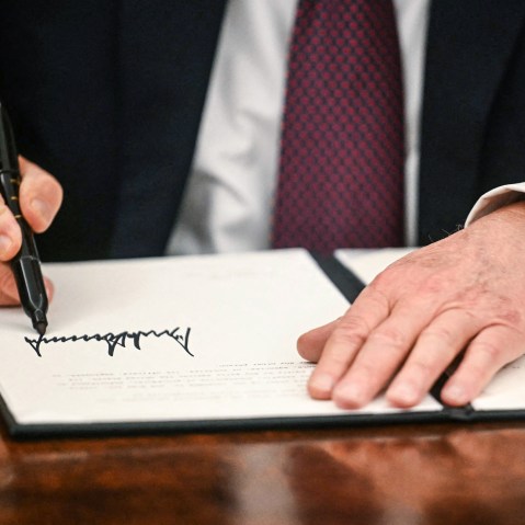 Image: President Donald Trump signs executive orders in the Oval Office
